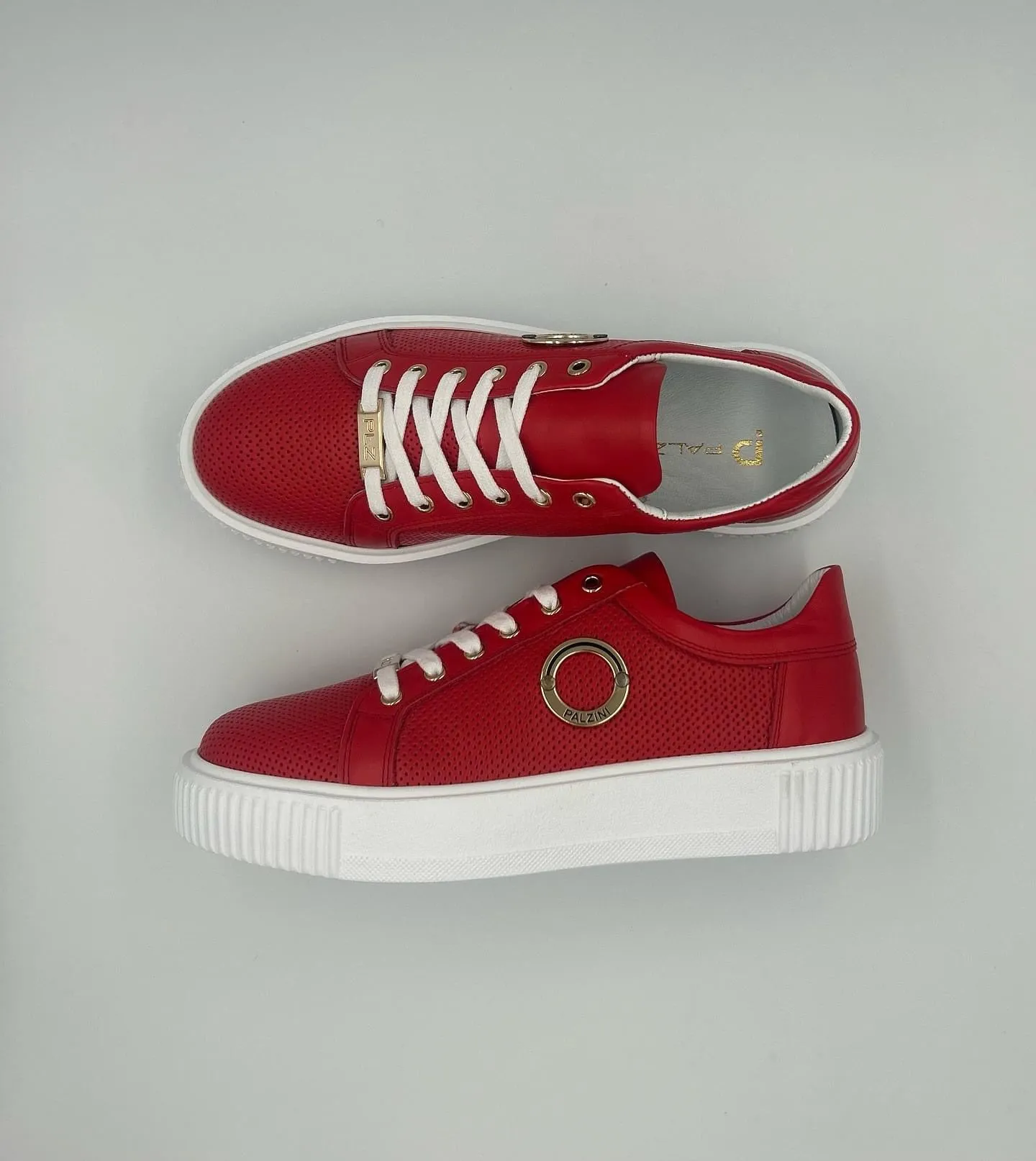 “P-7” LOW-TOP SNEAKERS IN RED LEATHER WITH GOLD RING AND PERFORATED SIDE.